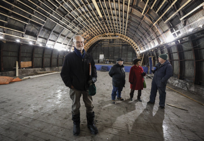 <who> Photo Credit: Canadian Press</who> Fred Bradley, left, who leads efforts to refurbish a Quonset hut theatre originally built in 1948, tours the building with other committee members in Coleman, Alta., Monday, Nov. 25, 2024.