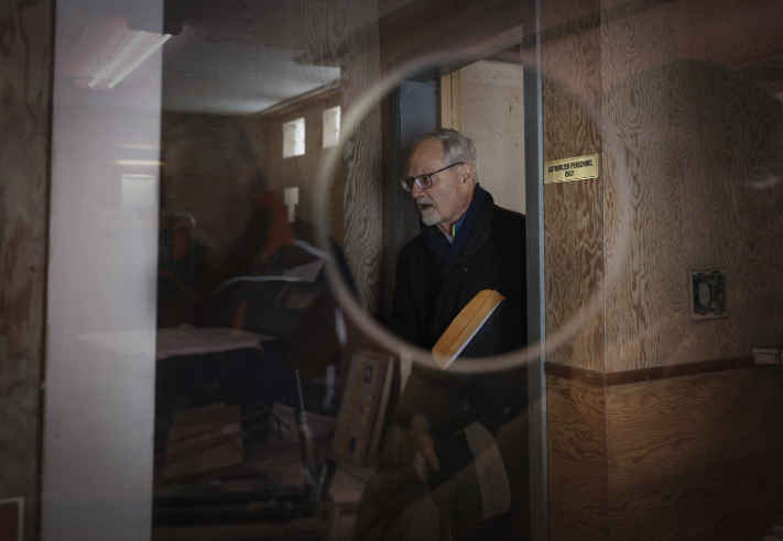 <who> Photo Credit: Canadian Press</who> Fred Bradley, who leads efforts to refurbish a Quonset hut theatre originally built in 1948, is seen through the theatre's ticket window in Coleman, Alta., Monday, Nov. 25, 2024.