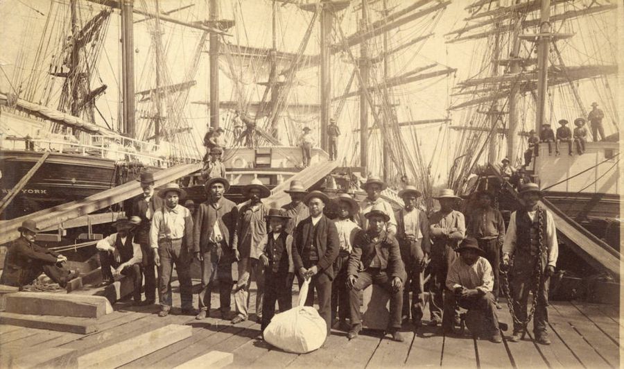<who> Photo Credit: City of Vancouver archives</who>William Nahanee (centre) poses with a group of longshoremen on the dock of Moodyville Sawmill in 1889.