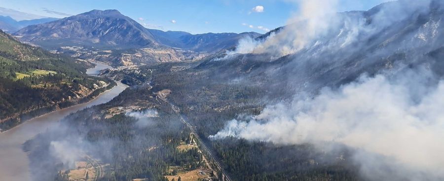 <who>Photo Credit: BC Wildfire Service</who>Lytton can be seen to the north in this photo of the Saw Creek wildfire.